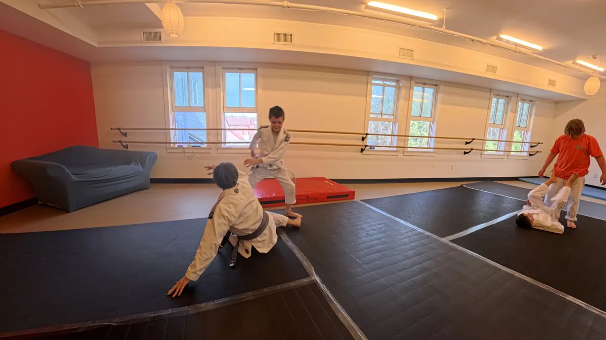 Coach guiding kids through a beginner-friendly Brazilian Jiu Jitsu class in Tannersville NY
