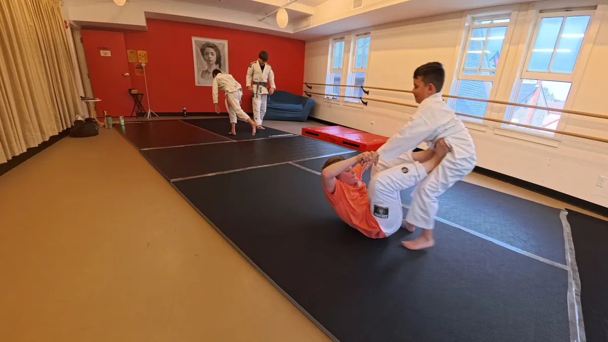 Coach guiding children through a structured after-school Jiu Jitsu class in Tannersville