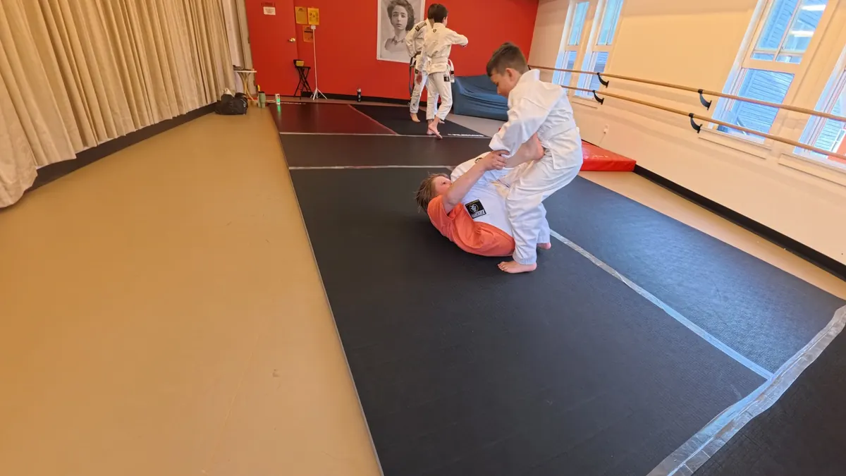 Student practicing a safe falling movement on the mats in Tannersville NY