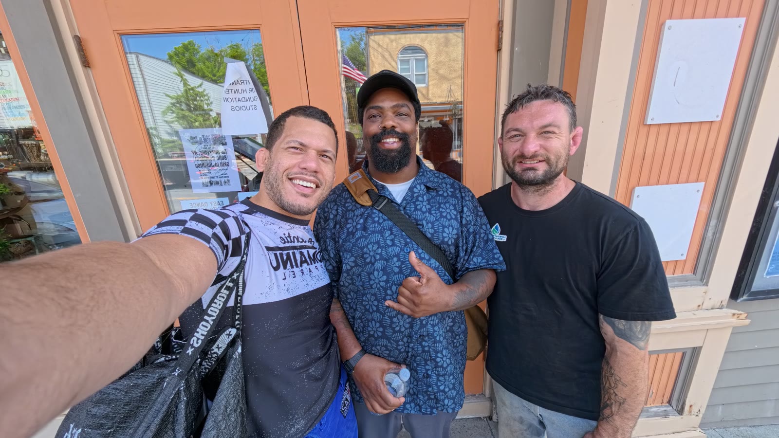 Three adults outside the Sensei Sandy BJJ studio entrance on Main Street in Tannersville NY