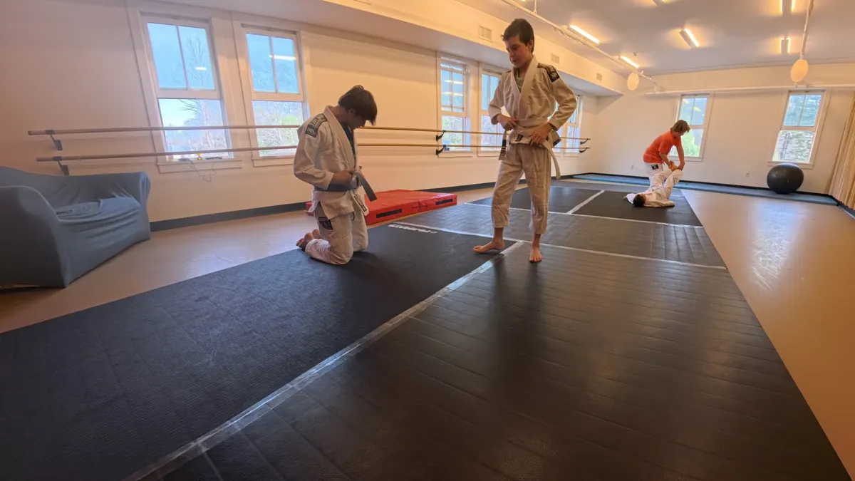 Kids Brazilian Jiu Jitsu class in Tannersville NY with instructor helping students on the mats