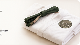 Folded Sensei Sandy BJJ gi with green belt
