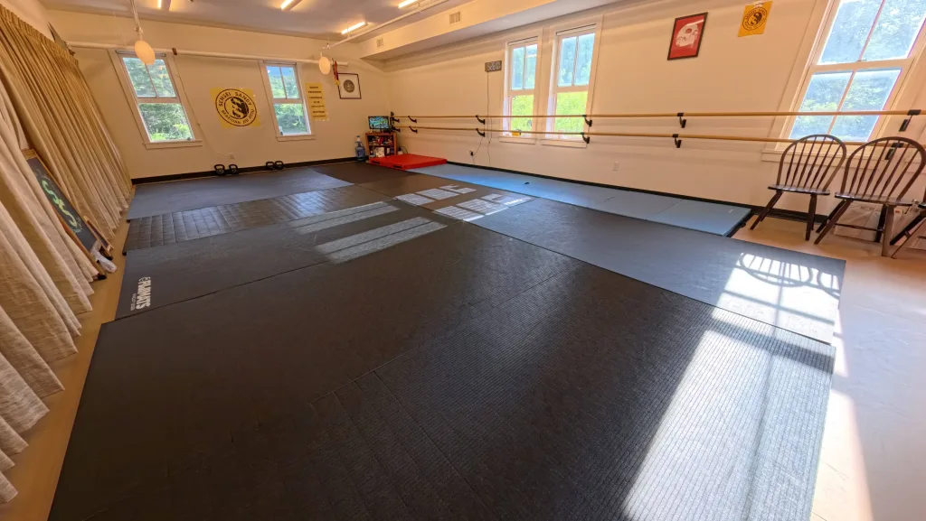 Clean matted training room and viewing area at Sensei Sandy BJJ in Tannersville