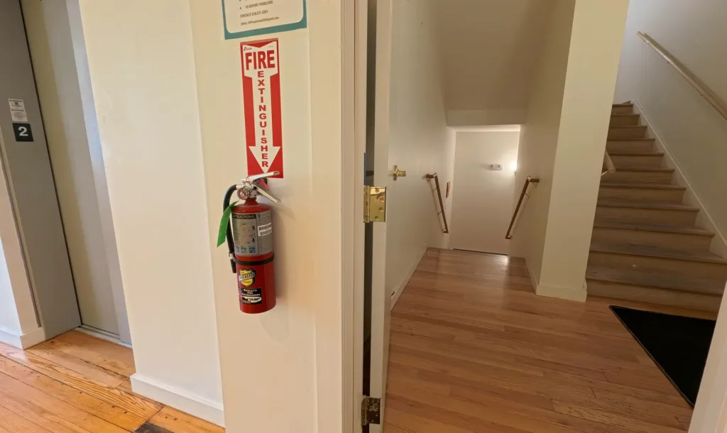 Stairs and elevator area leading toward the second floor at Studios on Main
